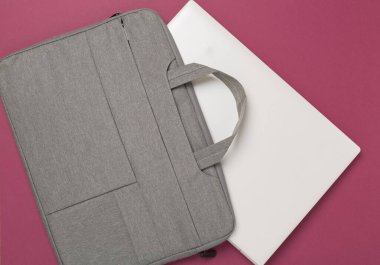 Renkli arka planda gri renkli dizüstü bilgisayar çantası, üst görünüm