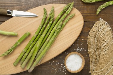 Fresh asparagus on wooden background, top view