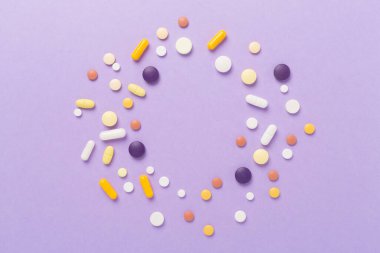 Different pills on color background, top view clipart