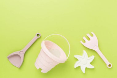 Renkli arka planda kumla oynamak için sevimli oyuncaklar, üst görünüm