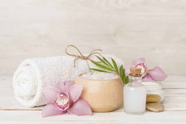 Composition with orchids, spa products on wooden table