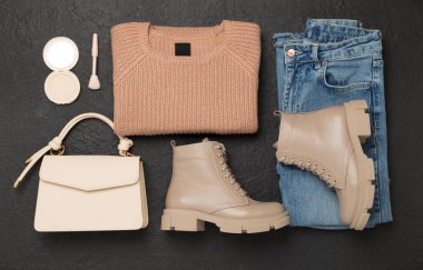 Beton arka planda modaya uygun bahar kıyafetleriyle yatıyordu.