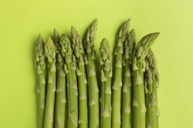 Fresh asparagus on wooden background, top view