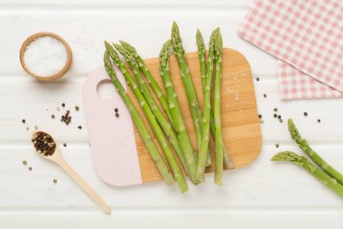 Fresh asparagus on wooden background, top view