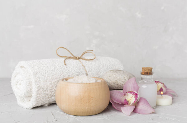 Composition with orchids, spa products on concrete table