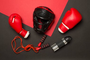 Boxing helmet and gloves on wooden background, top view. clipart