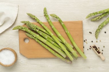 Fresh asparagus on wooden background, top view