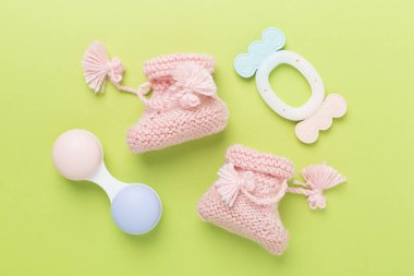 Renkli arka planda pembe bebek paçaları ve tıkırtılar, üst görünüm