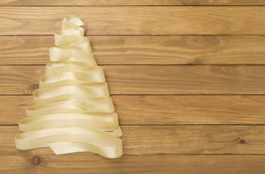 Creative ribbon christmas tree on wooden background, top, view clipart