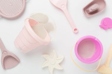 Renkli arka planda kumla oynamak için sevimli oyuncaklar, üst görünüm