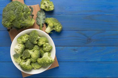 Ahşap zemin üzerinde taze lezzetli brokoli, üst manzara.