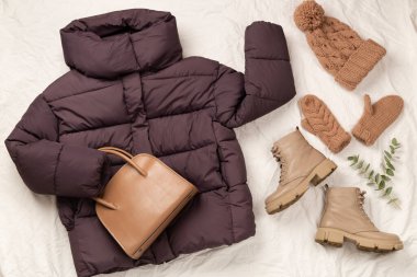 Beyaz çarşaf ve üst manzara üzerinde kadınların modaya uygun bahar kıyafetleriyle yatıyordu.