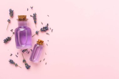 Renkli arka planda lavanta özlü şişeler, üst görünüm
