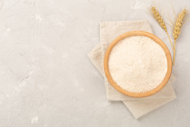 Beton arka planda hecelenmiş un ile kase, üst görünüm