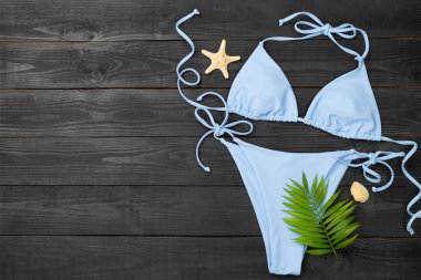 Ahşap arka planda mavi bikini, üst manzara