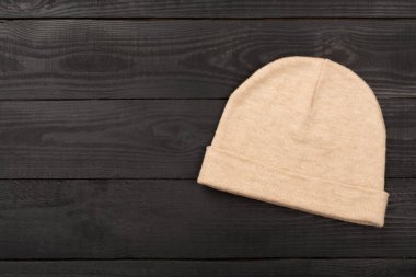 Ahşap arka planda şık bir bere, üst manzara.