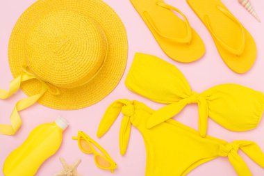 Düz yatıyordu, sarı yaz kıyafeti ve renk arka planı vardı. Tatil kavramı