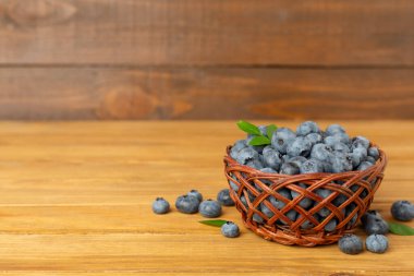 ahşap masa üzerinde taze yaban mersini ile kase