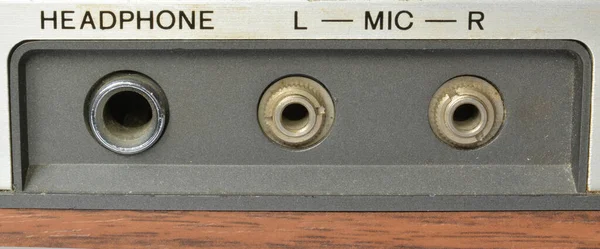 An auxiliary port for headphone and microphone on vintage tape recorder