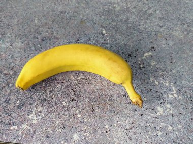 Banana on a gray background. Tropical fruit. View from above 