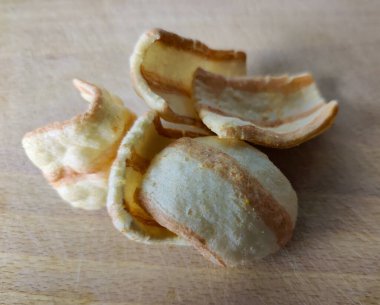Bacon. Several slices of fried bacon on a wooden board. Close-up. Finished product