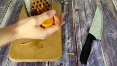 The chef rubs the carrot into the pan with a grater.  Borscht cooking