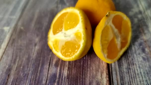 Halves Tangerines Whole Moldy Citrus Wooden Table View — Vídeo de stock