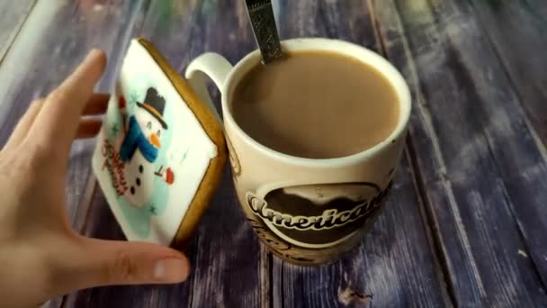 Person Takes Snowman Cookie Bites Piece Puts Back Next Cup — Stockvideo