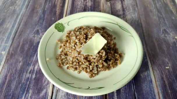 Boiled Buckwheat White Plate Butter Wooden Table Ready Meal — Αρχείο Βίντεο