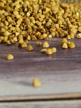 Raw buckwheat in a wooden table. Close-up