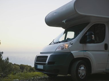 Motorhome close up by the sea parked to overnight clipart