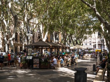 Palma de Mallorca, İspanya; 17 Eylül 2024: Turistler, Passeig del Born 'daki eski Palma de Mallorca kasabasında güneşli bir günün tadını çıkarıyorlar.