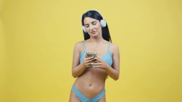 Beautiful Young Woman Headphones Yellow Background Listening Music Dancing Posing — Stock Video