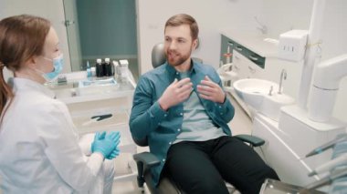 A female doctor discusses a dental restoration and rehabilitation plan with a patient