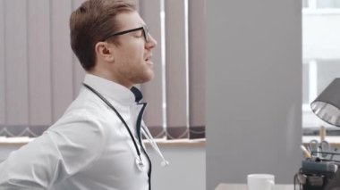 Senior Doctor having Back Pain while Working on Computer