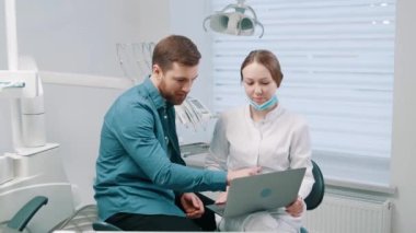 A female doctor discusses a dental restoration and rehabilitation plan with a patient. Dentistry