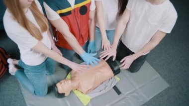 First aid resuscitation, CPR training. Students study in front of a dummy