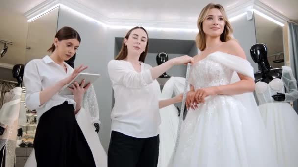 Wedding Dress Shop Owners Digital Tablet Helping Choose Bridal Gown — Stock Video