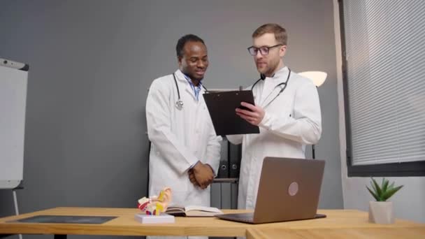 Two Doctors Lab Coats Analyzing Data Tablet — Stock Video