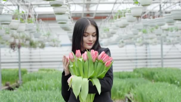 温室でチューリップの束を保持している女性 — ストック動画