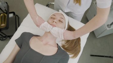 Doğal güzelliği geliştirmeye odaklanmış bir kız için kalıcı makyaj uygulaması sergileniyor.