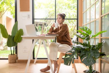 Young people work from home using smartphone connection for meeting with office.  Asia woman meeting conference connect online with office.  Business and Technology Concept