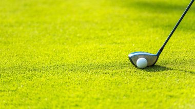 Golf sopası, golf topuyla birlikte yeşil tişörte vuruyor. Yaşam tarzı ve Sağlıklı Kavram. Pankart için alanı kopyala