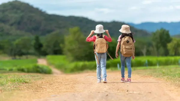 Group friend children travel nature summer trips.  Family Asia people tourism walking on road happy and fun explore adventure outdoors for leisure and destination, mountain background. Travel Lifestyle Concept