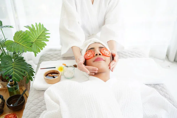 Friend girl help masking face with tomato and spa face woman treatment and massage aroma therapy relax enjoying and healthy and beauty. Spa Thai therapy treatment aromatherapy for body and face