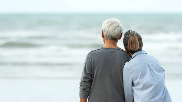 Asian Lifestyle senior couple hug on the beach happy in love romantic and relax time. People tourism elderly family travel leisure and activity