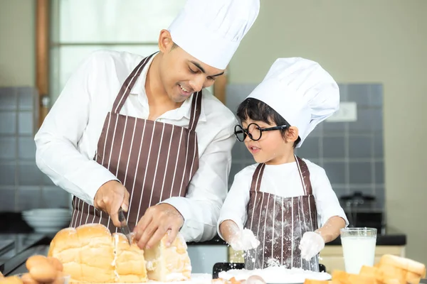 Lifestyle Family. Chef asian father and kid boy cooking toast and make  bread for dinner.  Asian son help mom making sweet food, so happy and enjoy.  Family Concept