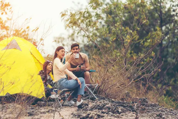 Group tourism and travel hiker adventure on mountain nature landscape. People lifestyle tourist backpack drinking coffee and camping outdoors for relax summer time