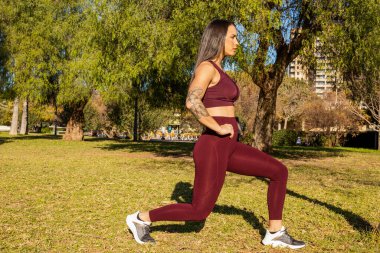sporty woman doing exercises and stretching outdoors