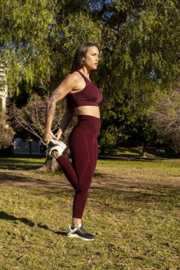sporty woman doing exercises and stretching outdoors